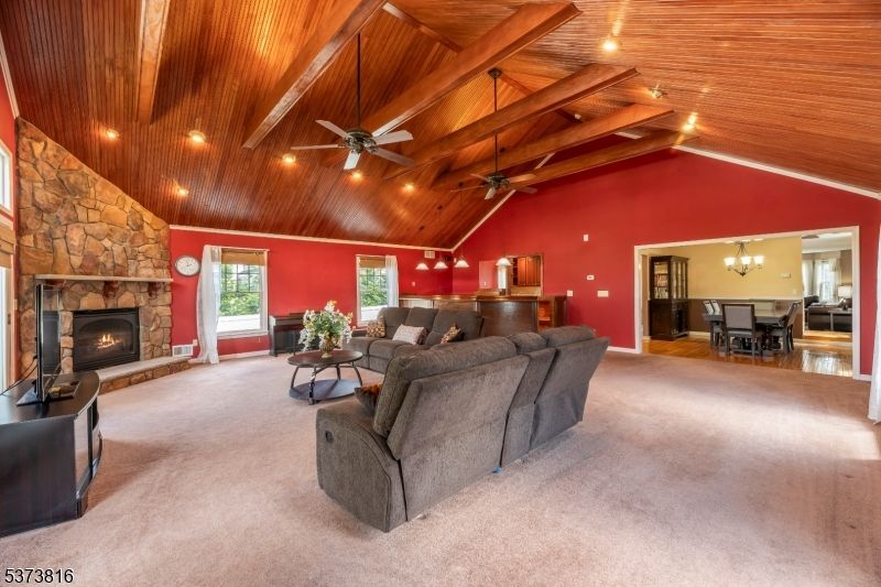 Chandelier, Dining room, Fireplace, Interior, Living room, Recessed Lighting, Stone Walls, Wooden Beams, Wooden Ceilings