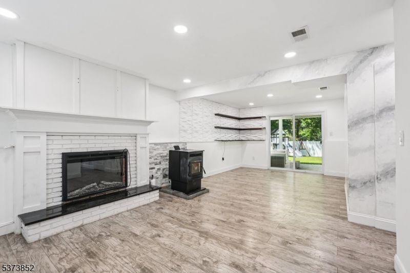 Fireplace, Interior, Marble Walls, Recessed Lighting, Wood Texture Flooring