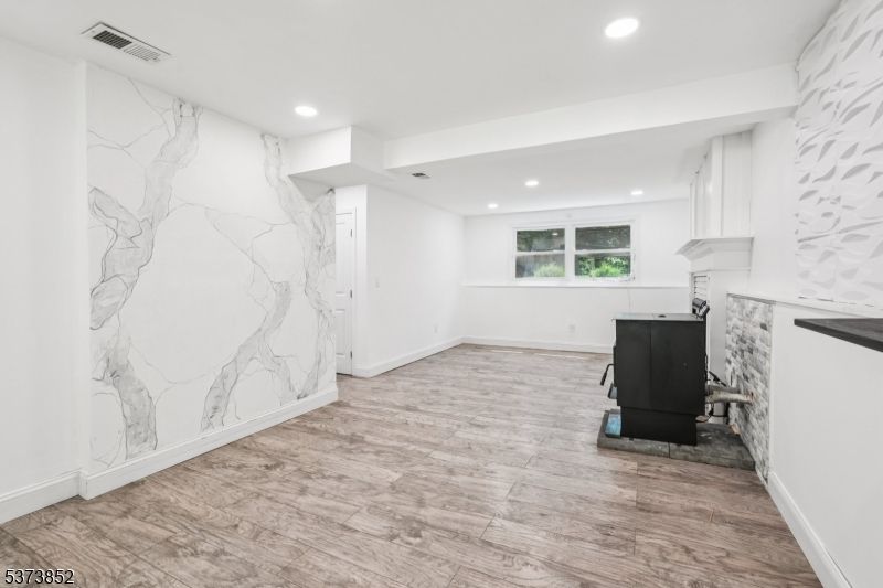 Fireplace, Interior, Marble Walls, Recessed Lighting, Wood Texture Flooring