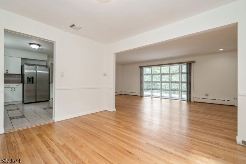 Empty room, Interior, Kitchen, Recessed Lighting, Stainless Steel Appliances, Wood Texture Flooring