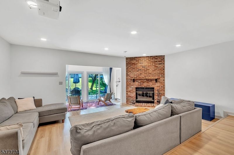 Fireplace, Interior, Living room, Recessed Lighting, Stone Walls, Wood Texture Flooring