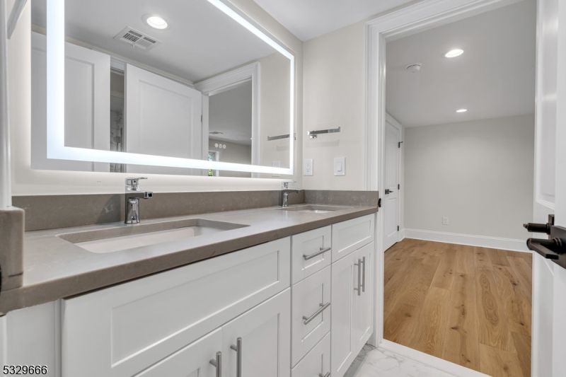 Bathroom, Dual Sink Vanities, Interior, Marble, Recessed Lighting, Wood Texture Flooring