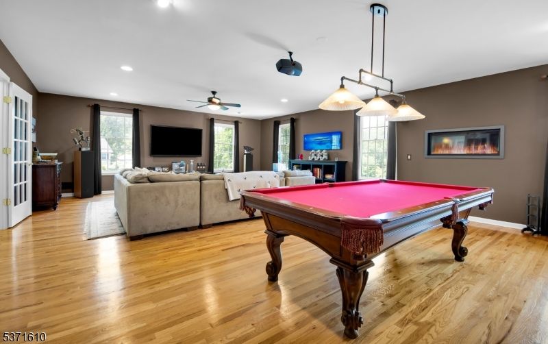 Billiard Table, Fireplace, Game Room, Interior, Living room, Pendant Lights, Recessed Lighting, Wood Texture Flooring