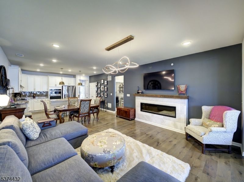 Dining room, Fireplace, Interior, Kitchen, Living room, Pendant Lights, Recessed Lighting, Stainless Steel Appliances, Wood Texture Flooring