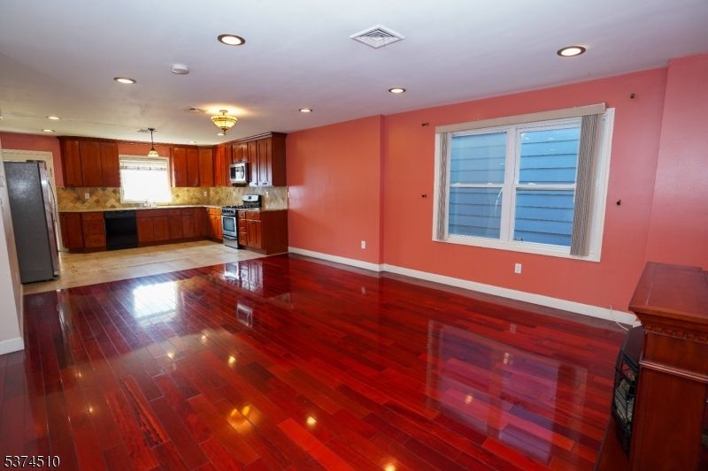Empty room, Interior, Kitchen, Pendant Lights, Recessed Lighting, Stainless Steel Appliances, Wood Texture Flooring