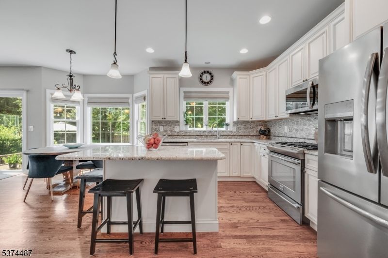 Dining room, Interior, Kitchen, Pendant Lights, Recessed Lighting, Stainless Steel Appliances, Wood Texture Flooring