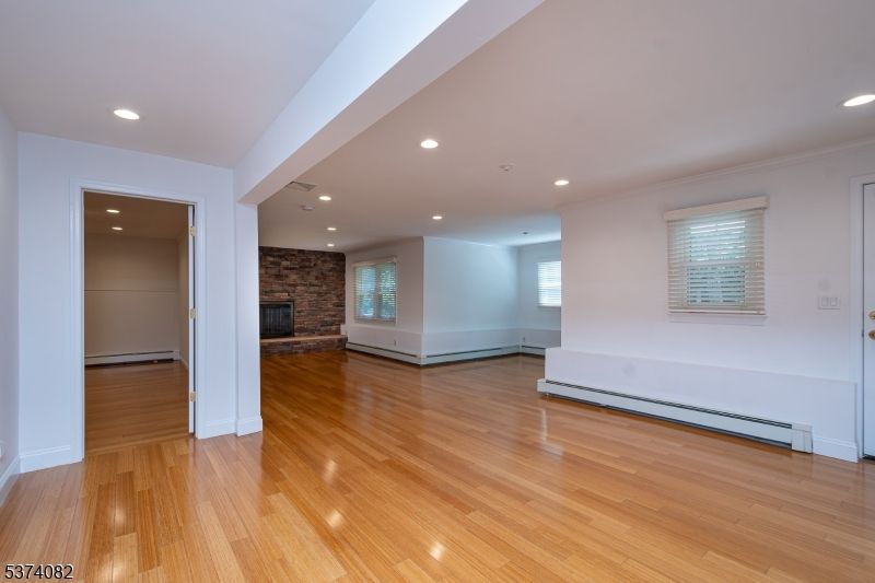 Empty room, Fireplace, Interior, Recessed Lighting, Stone Walls, Wood Texture Flooring