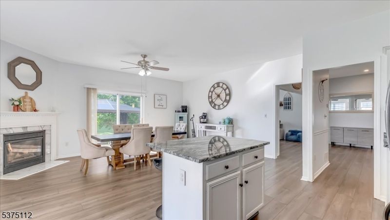 Dining room, Fireplace, Interior, Kitchen, Recessed Lighting, Wood Texture Flooring