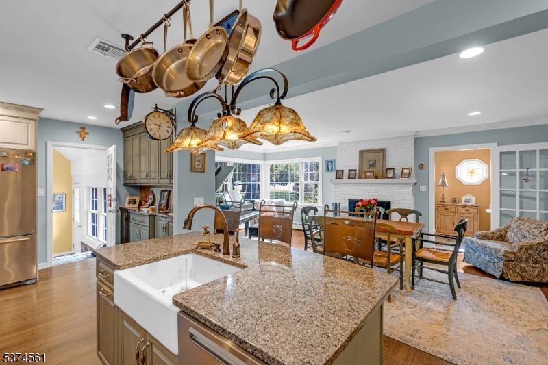 Dining room, Fireplace, Interior, Kitchen, Recessed Lighting, Stainless Steel Appliances, Wood Texture Flooring