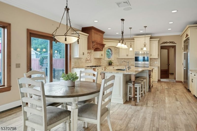 Dining room, Interior, Kitchen, Pendant Lights, Recessed Lighting, Stainless Steel Appliances, Wood Texture Flooring