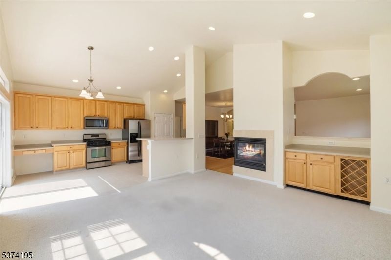 Chandelier, Empty room, Fireplace, Interior, Kitchen, Pendant Lights, Recessed Lighting, Stainless Steel Appliances