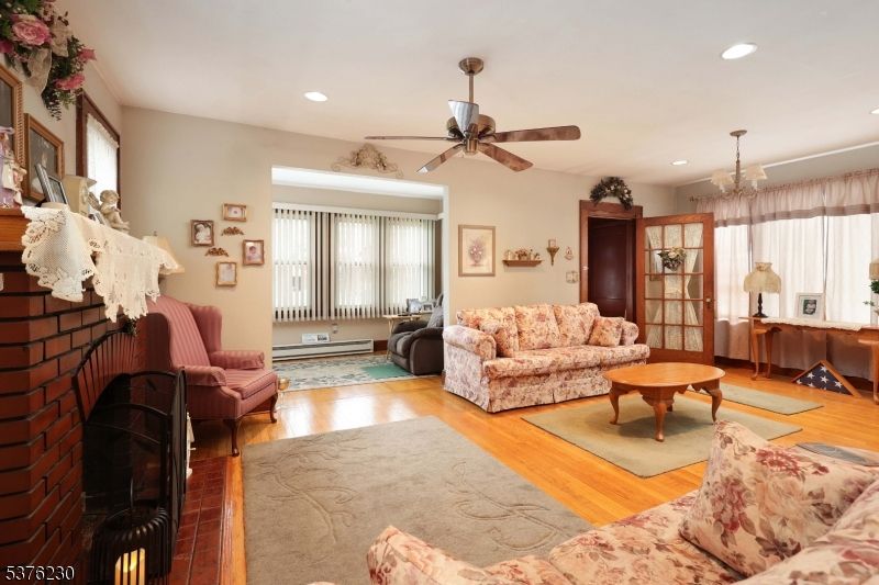 Chandelier, Fireplace, Interior, Living room, Recessed Lighting, Wood Texture Flooring