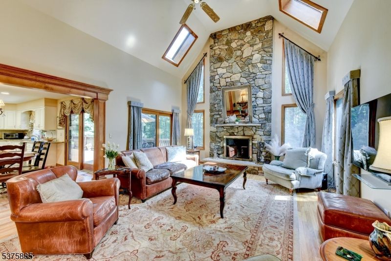 Dining room, Fireplace, Interior, Kitchen, Living room, Recessed Lighting, Stone Walls, Wood Texture Flooring