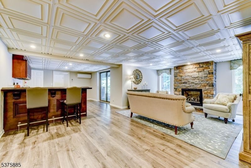 Fireplace, Interior, Living room, Recessed Lighting, Stone Walls, Wood Texture Flooring