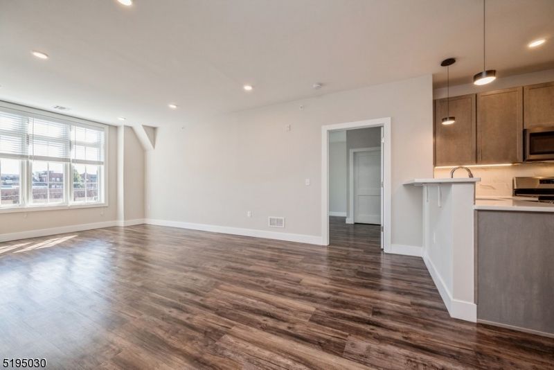 Empty room, Interior, Kitchen, Pendant Lights, Recessed Lighting, Stainless Steel Appliances, Wood Texture Flooring