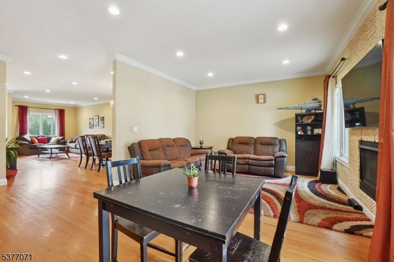 Dining room, Fireplace, Interior, Living room, Recessed Lighting, Wood Texture Flooring