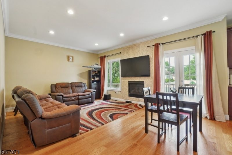 Dining room, Fireplace, Interior, Living room, Recessed Lighting, Wood Texture Flooring