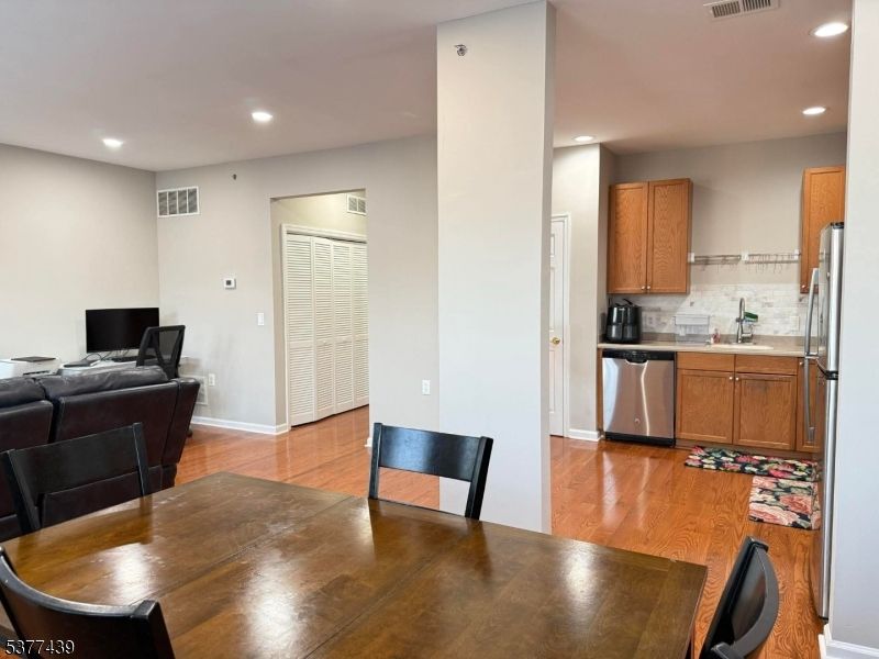 Dining room, Interior, Kitchen, Living room, Recessed Lighting, Stainless Steel Appliances, Wood Texture Flooring
