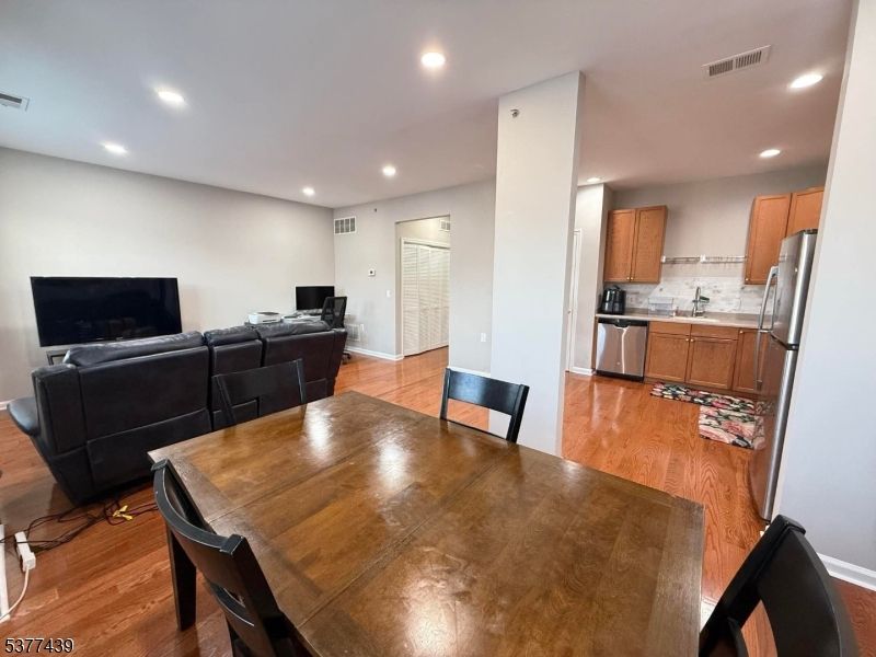 Dining room, Interior, Kitchen, Living room, Recessed Lighting, Stainless Steel Appliances, Wood Texture Flooring