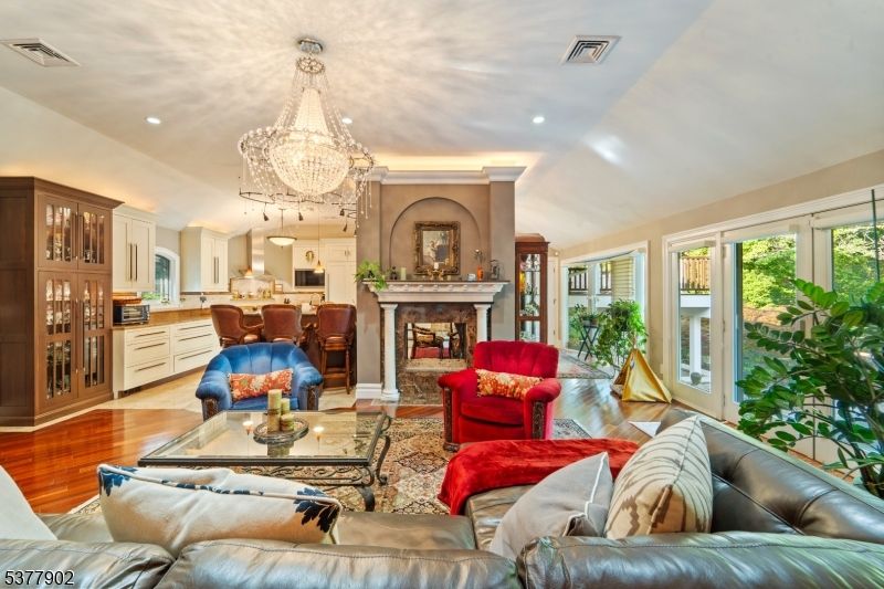 Chandelier, Fireplace, Interior, Kitchen, Living room, Recessed Lighting, Wood Texture Flooring
