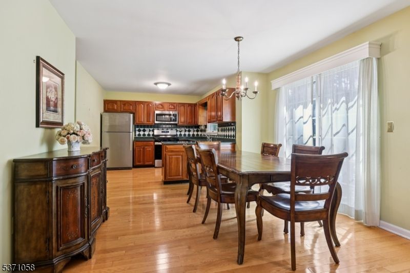 Chandelier, Dining room, Interior, Kitchen, Pendant Lights, Stainless Steel Appliances, Wood Texture Flooring