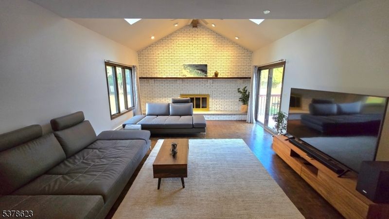 Fireplace, Interior, Living room, Recessed Lighting, Stone Walls, Wood Texture Flooring