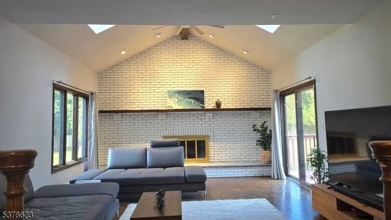 Fireplace, Interior, Living room, Recessed Lighting, Stone Walls, Wood Texture Flooring