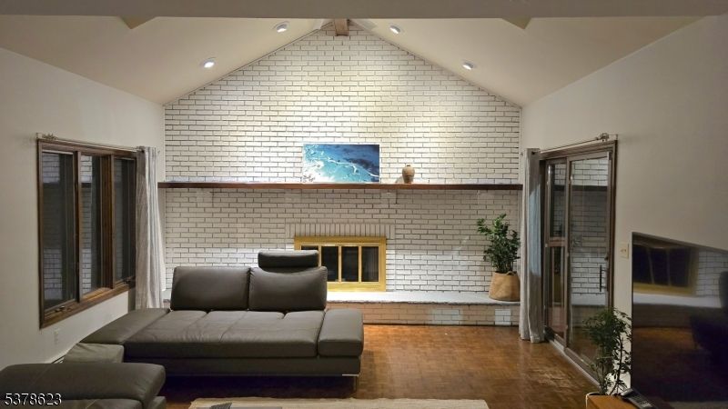 Fireplace, Interior, Living room, Recessed Lighting, Stone Walls, Wood Texture Flooring