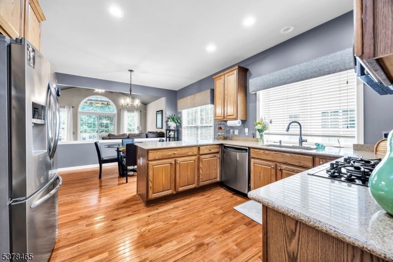 Chandelier, Dining room, Interior, Kitchen, Recessed Lighting, Stainless Steel Appliances, Wood Texture Flooring