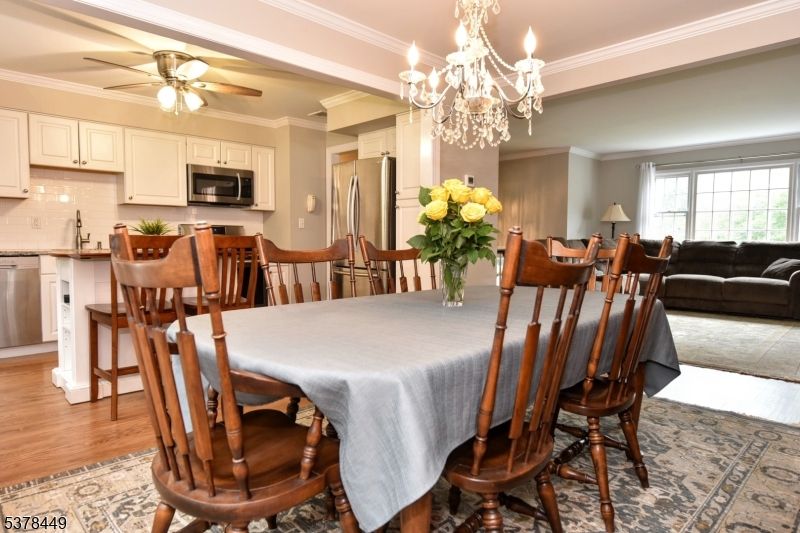 Chandelier, Dining room, Interior, Kitchen, Living room, Stainless Steel Appliances, Wood Texture Flooring