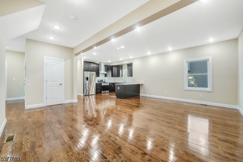 Empty room, Interior, Kitchen, Recessed Lighting, Stainless Steel Appliances, Wood Texture Flooring