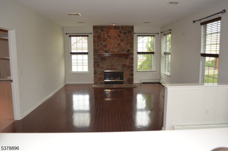 Empty room, Fireplace, Interior, Recessed Lighting, Stone Walls, Wood Texture Flooring