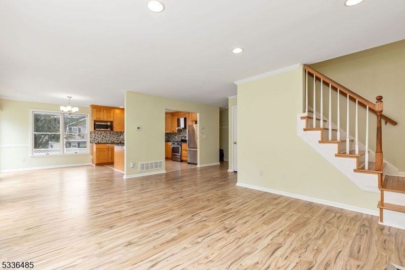 Chandelier, Empty room, Interior, Kitchen, Recessed Lighting, Stainless Steel Appliances, Wood Texture Flooring
