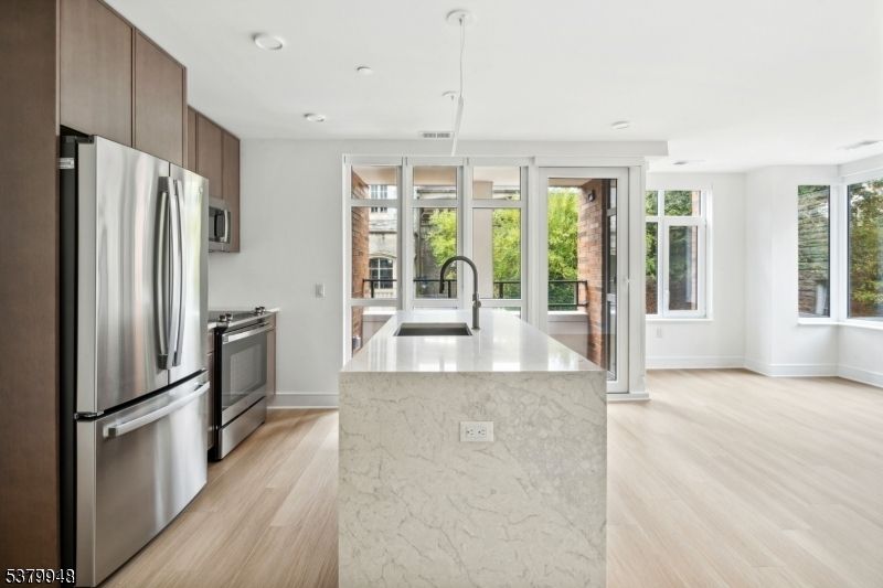 Interior, Kitchen, Marble Walls, Pendant Lights, Recessed Lighting, Stainless Steel Appliances, Wood Texture Flooring