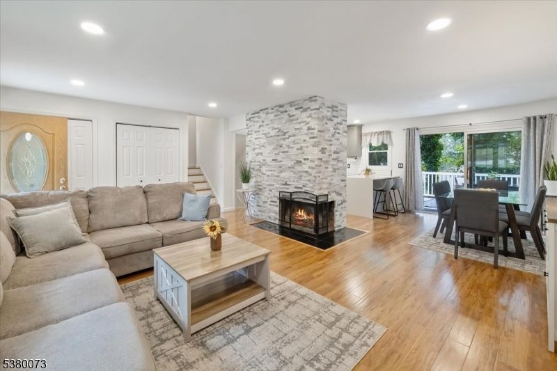 Dining room, Fireplace, Interior, Living room, Recessed Lighting, Stone Walls, Wood Texture Flooring