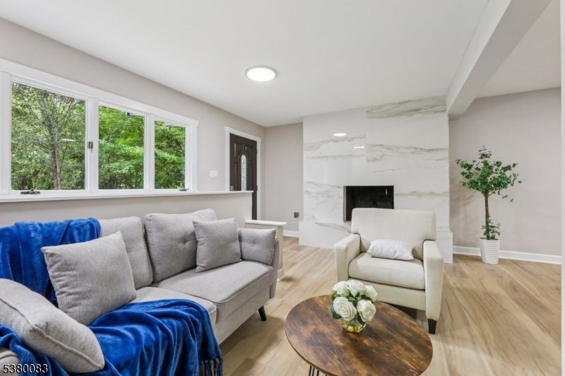 Fireplace, Interior, Living room, Marble Walls, Recessed Lighting, Wood Texture Flooring