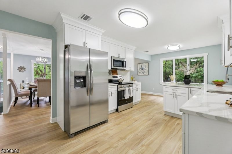 Chandelier, Dining room, Interior, Kitchen, Stainless Steel Appliances, Wood Texture Flooring