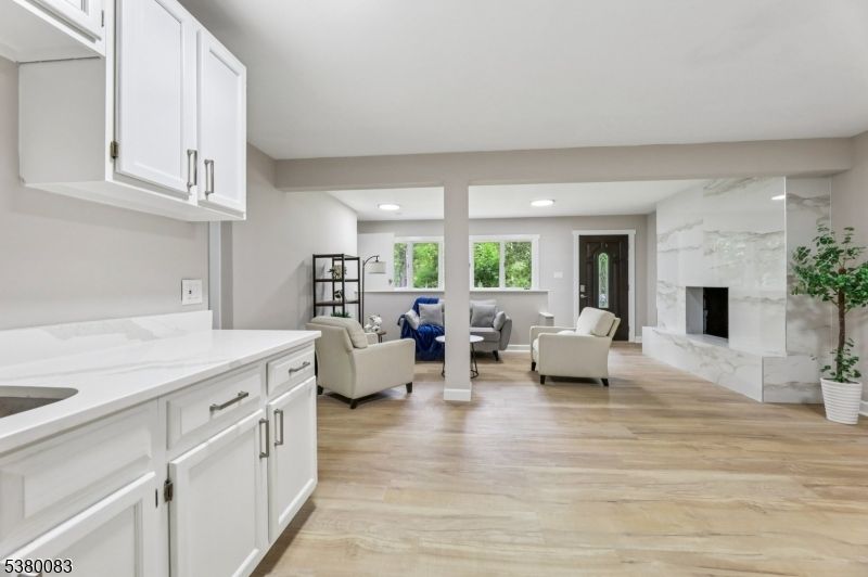 Fireplace, Interior, Living room, Marble Walls, Recessed Lighting, Wood Texture Flooring