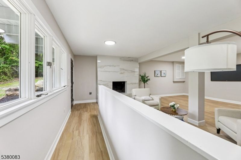 Fireplace, Interior, Living room, Marble Walls, Recessed Lighting, Wood Texture Flooring