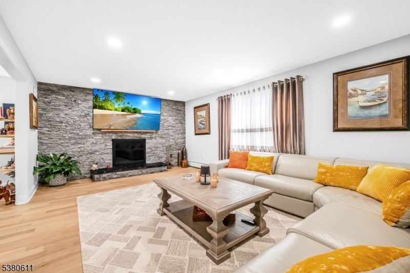 Fireplace, Interior, Living room, Recessed Lighting, Stone Walls, Wood Texture Flooring