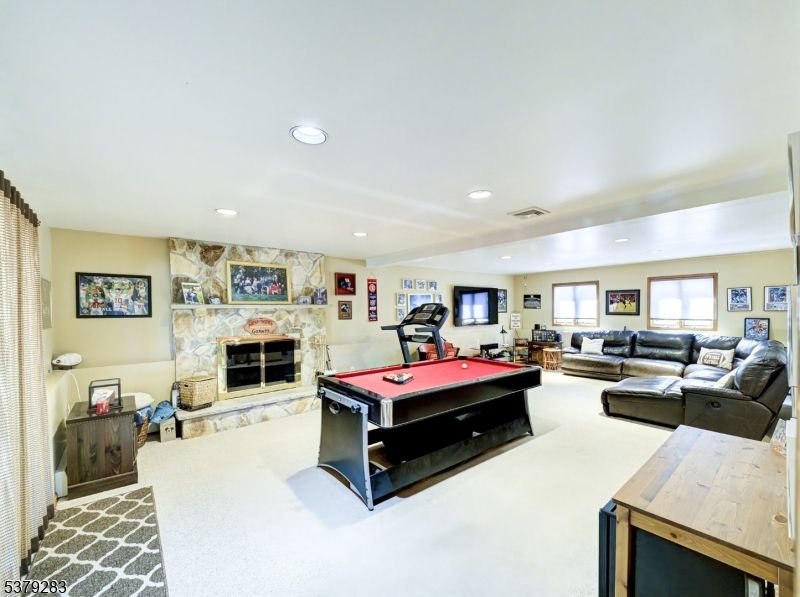 Fireplace, Fitness Equipment, Game Room, Interior, Living room, Recessed Lighting, Stone Walls