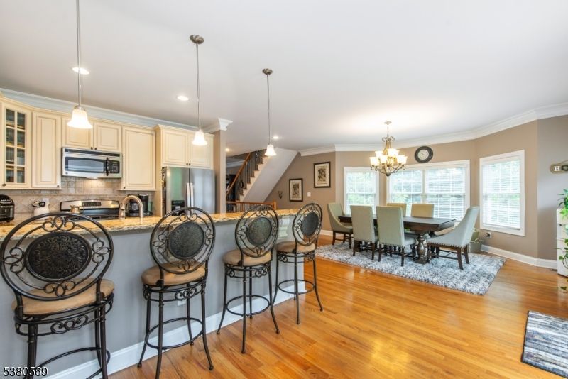 Chandelier, Dining room, Interior, Kitchen, Pendant Lights, Recessed Lighting, Stainless Steel Appliances, Wood Texture Flooring