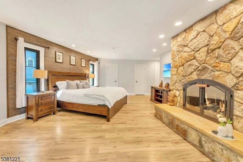 Bedroom, Fireplace, Interior, Recessed Lighting, Stone Walls, Wood Texture Flooring