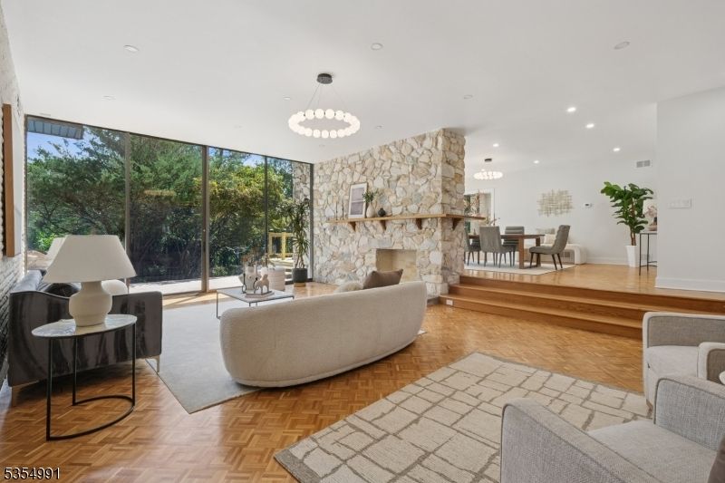 Chandelier, Dining room, Fireplace, Interior, Living room, Pendant Lights, Recessed Lighting, Stone Walls, Wood Texture Flooring