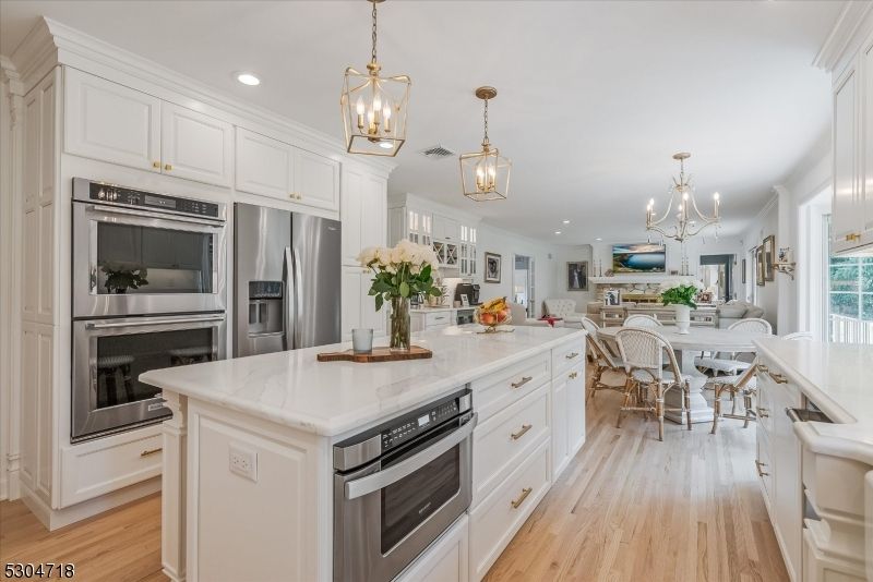 Chandelier, Dining room, Interior, Kitchen, Pendant Lights, Recessed Lighting, Stainless Steel Appliances, Wood Texture Flooring