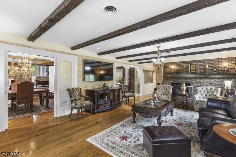Chandelier, Dining room, Fireplace, Interior, Living room, Stone Walls, Wooden Beams, Wood Texture Flooring