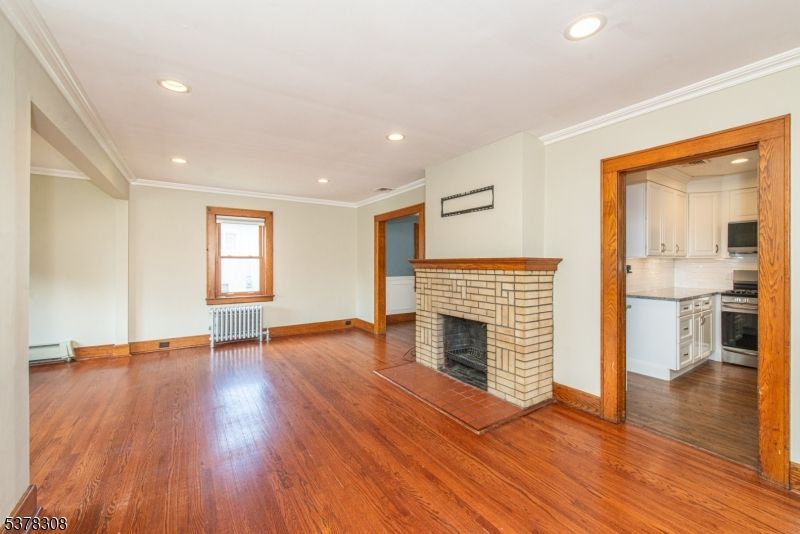 Empty room, Fireplace, Interior, Kitchen, Recessed Lighting, Wood Texture Flooring