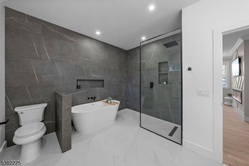 Bathroom, Free Standing Baths, Glass Shower, Interior, Marble, Marble Walls, Recessed Lighting, Wood Texture Flooring