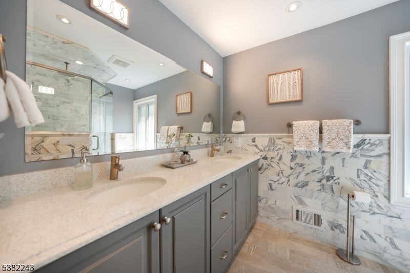 Bathroom, Dual Sink Vanities, Glass Shower, Interior, Marble Walls, Recessed Lighting