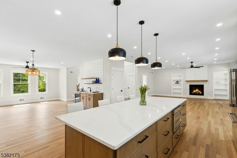 Empty room, Fireplace, Interior, Kitchen, Pendant Lights, Recessed Lighting, Wood Texture Flooring
